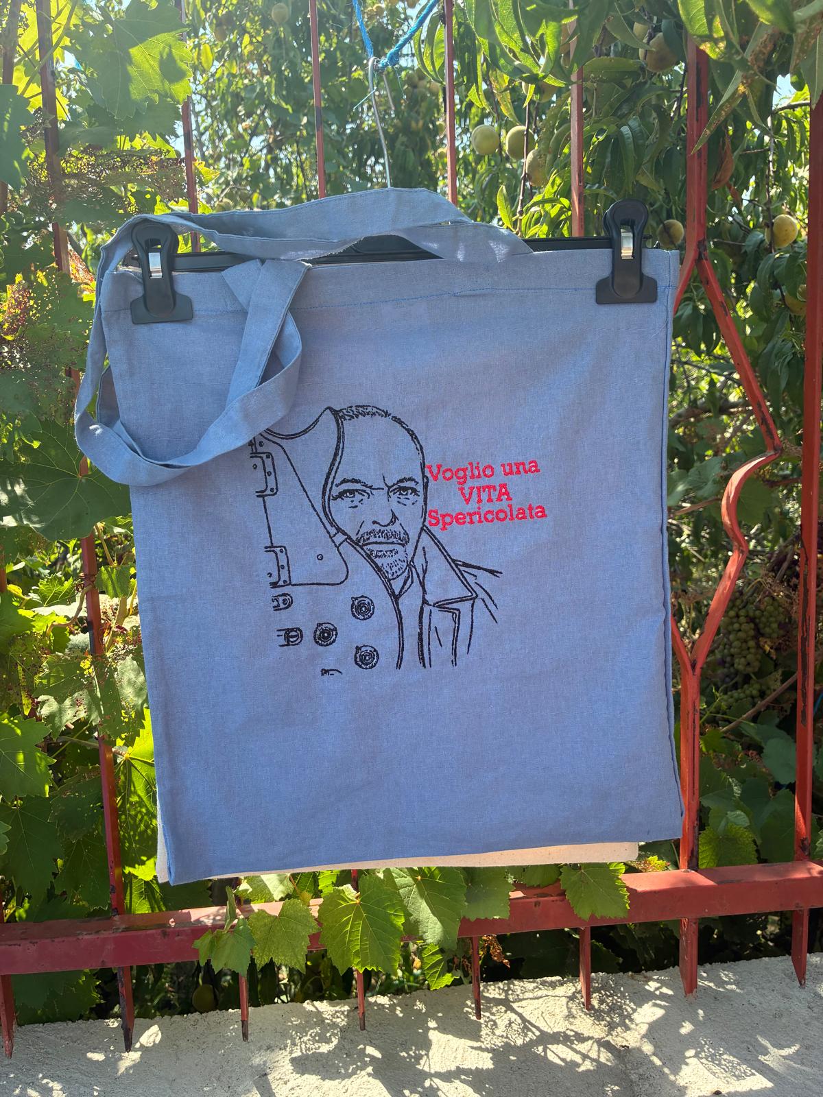 Tote bag azzurra con ritratto e scritta Vita spericolata ricamati